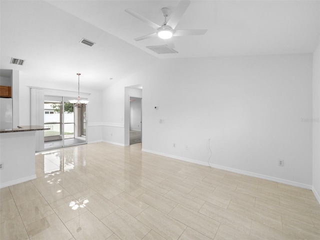 unfurnished living room featuring light tile patterned flooring, lofted ceiling, and ceiling fan with notable chandelier