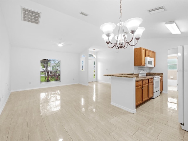 kitchen with lofted ceiling, white appliances, light tile patterned floors, light stone countertops, and decorative light fixtures