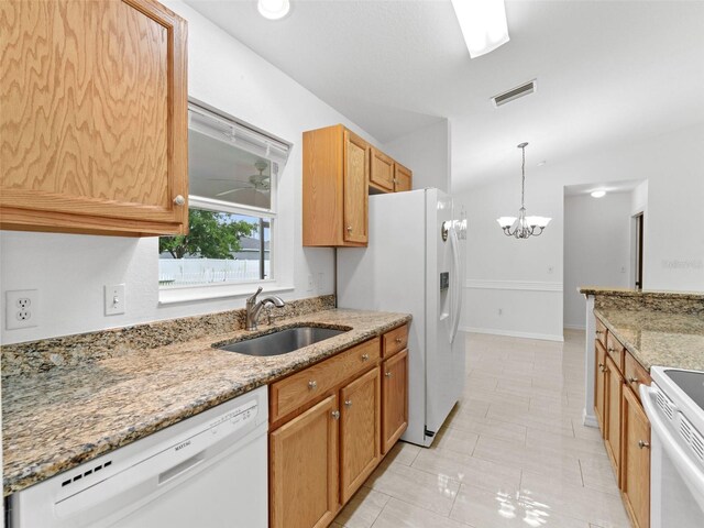 kitchen with light tile patterned flooring, white appliances, ceiling fan with notable chandelier, decorative light fixtures, and sink