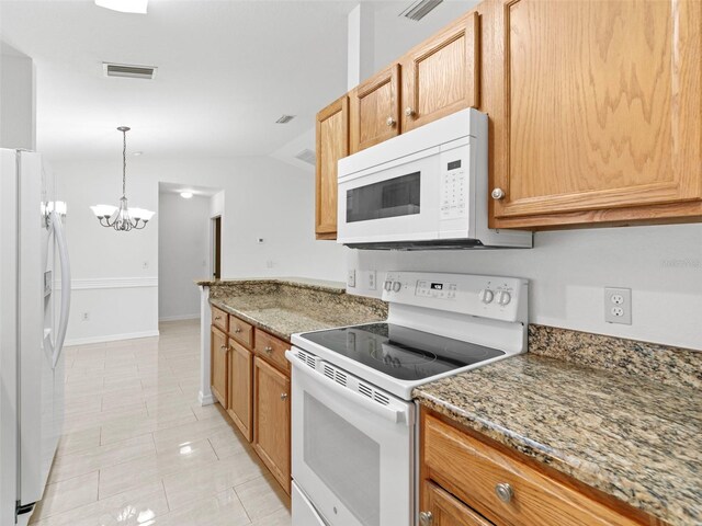 kitchen featuring white appliances, light tile patterned floors, a chandelier, stone countertops, and decorative light fixtures