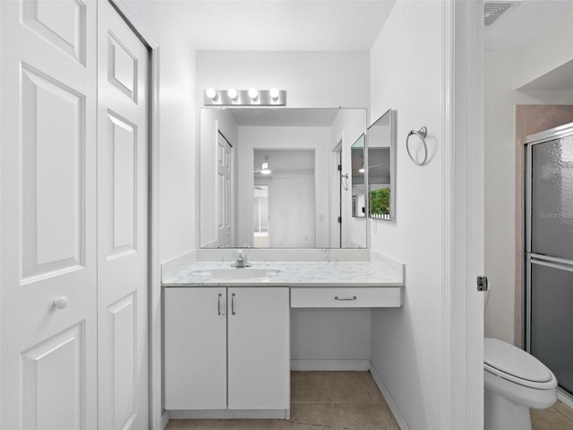 bathroom featuring vanity, tile patterned floors, and toilet