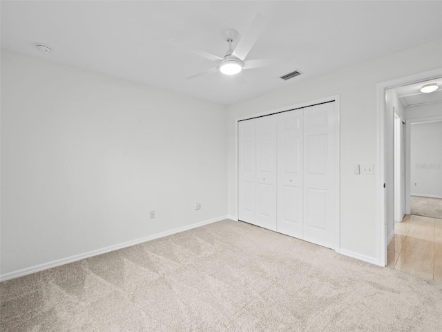 unfurnished bedroom with a closet, carpet, and ceiling fan