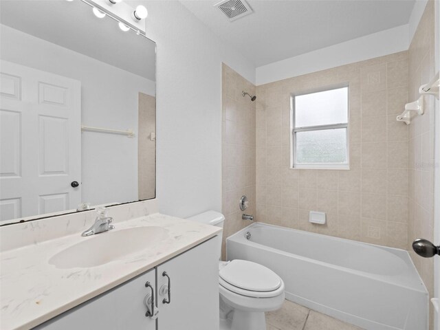 full bathroom featuring tile patterned floors, toilet, vanity, and tiled shower / bath