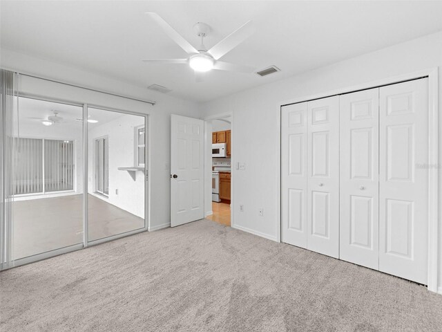 unfurnished bedroom with a closet, carpet floors, and ceiling fan