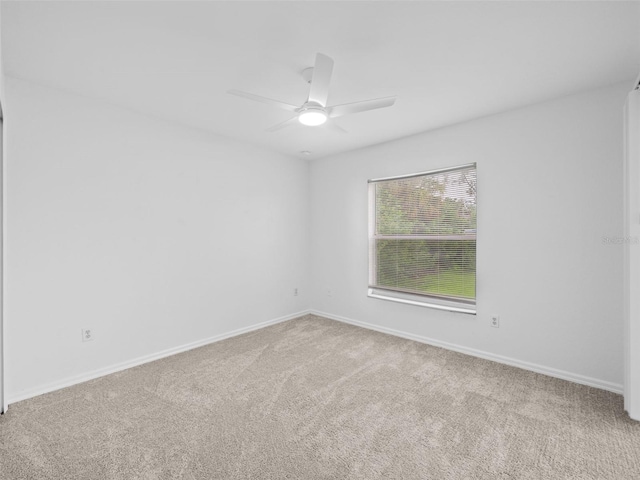 spare room with carpet flooring and ceiling fan