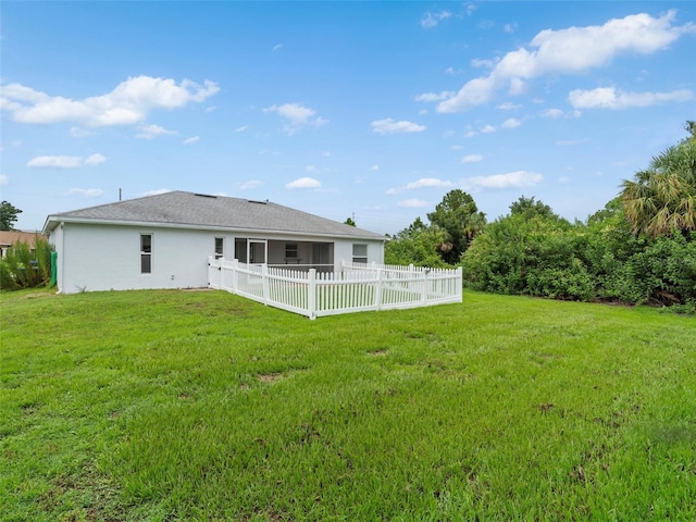 back of house featuring a yard