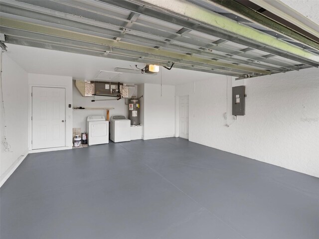 garage featuring a garage door opener, separate washer and dryer, water heater, and electric panel