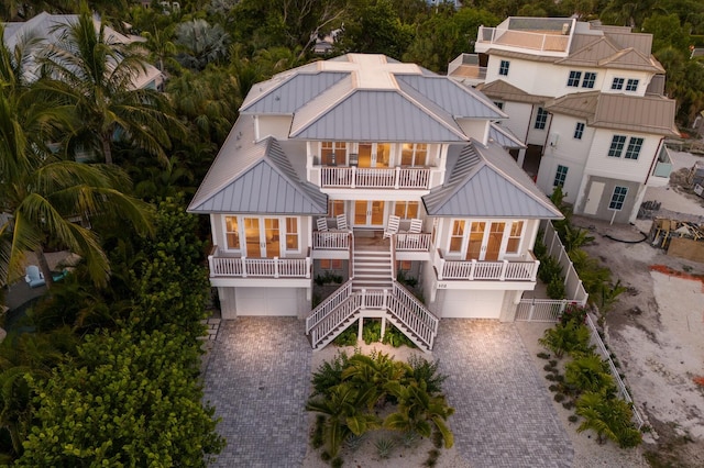 back of property with a garage and a balcony