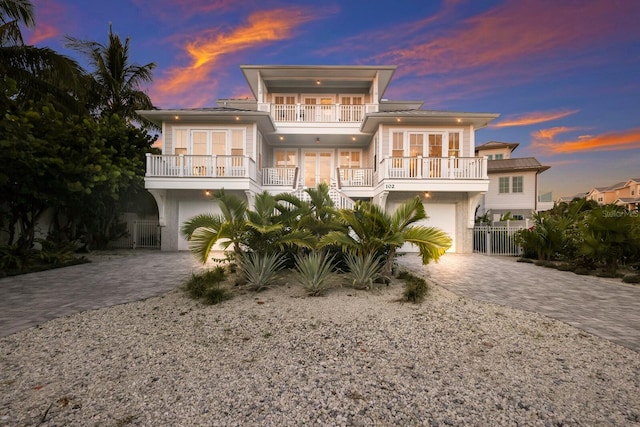 view of front facade with a balcony and a garage