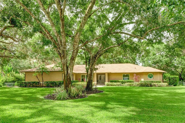 ranch-style home with a front yard