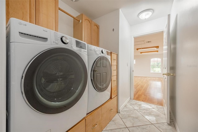 laundry area featuring cabinets and independent washer and dryer