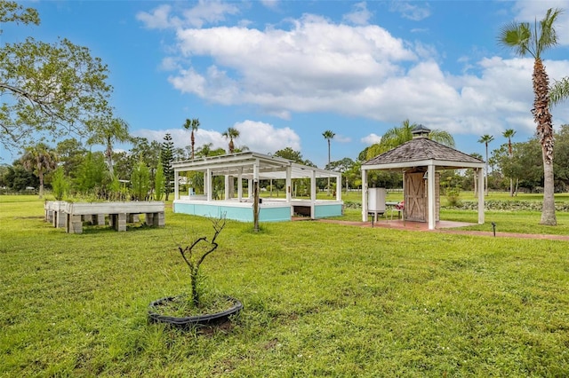 view of home's community featuring a pool, a gazebo, and a yard