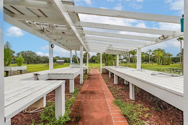 view of dock featuring a yard and a pergola