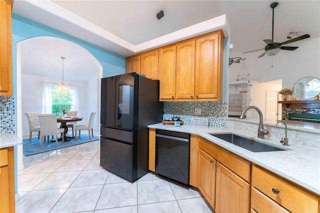 kitchen with black appliances, backsplash, hanging light fixtures, and sink