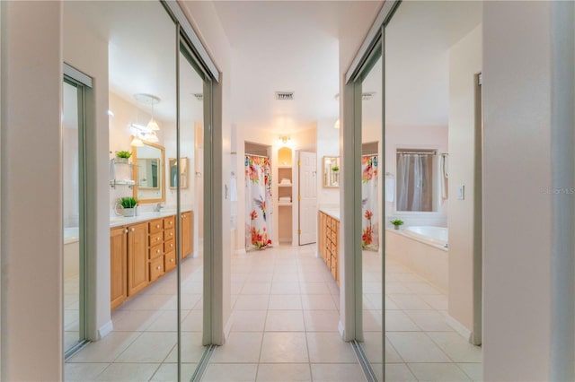 hall featuring light tile patterned floors