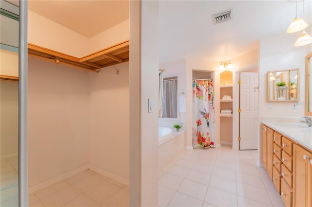 bathroom featuring vanity, tile patterned floors, and separate shower and tub