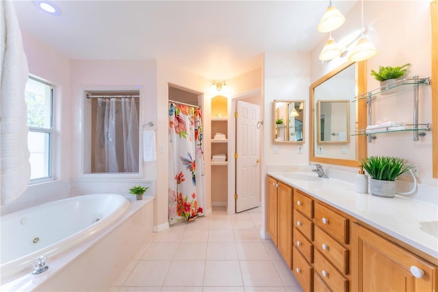 bathroom featuring tile patterned flooring, shower with separate bathtub, and vanity