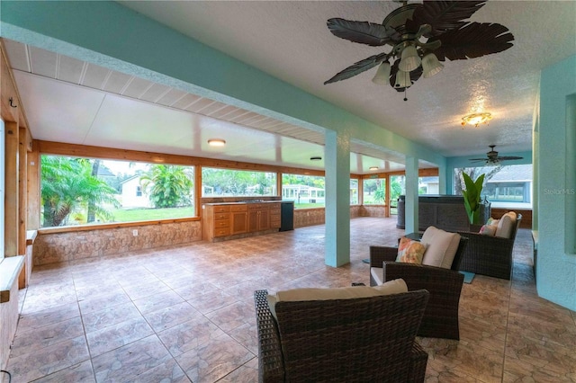 sunroom featuring ceiling fan