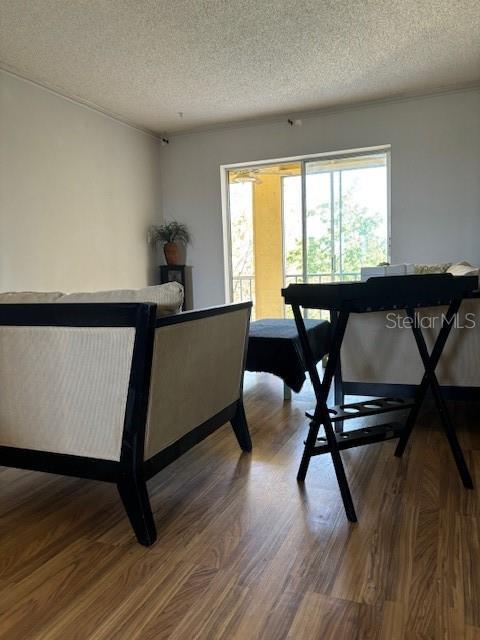 dining room with a textured ceiling and hardwood / wood-style floors