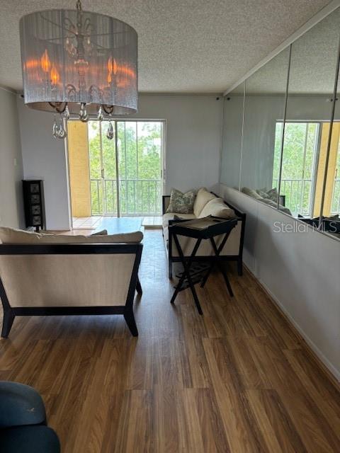 living room with hardwood / wood-style floors and a textured ceiling