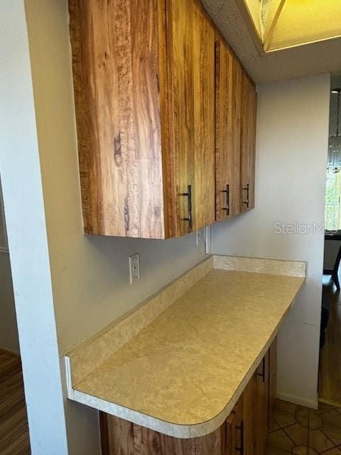 kitchen featuring dark tile patterned floors