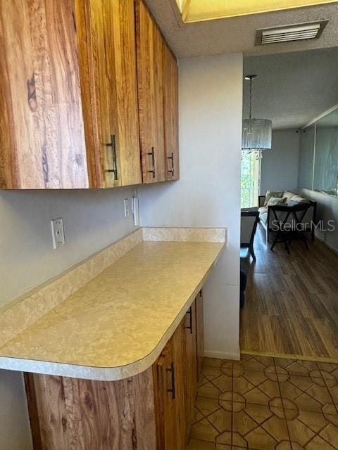 kitchen featuring tile patterned flooring and an inviting chandelier