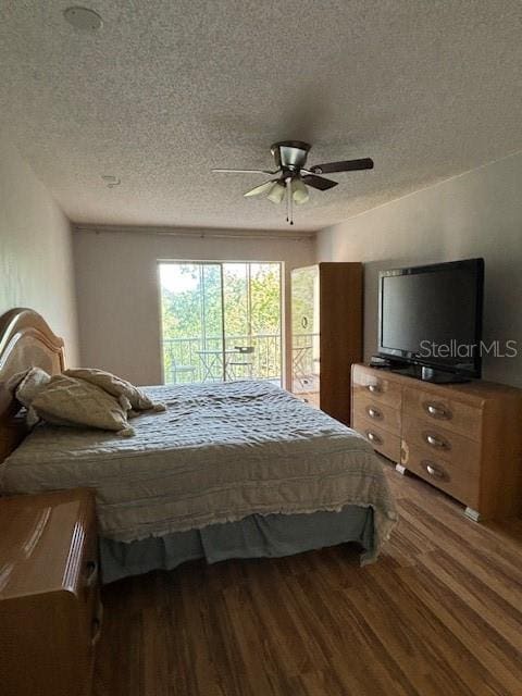 bedroom with ceiling fan, access to outside, a textured ceiling, and hardwood / wood-style floors