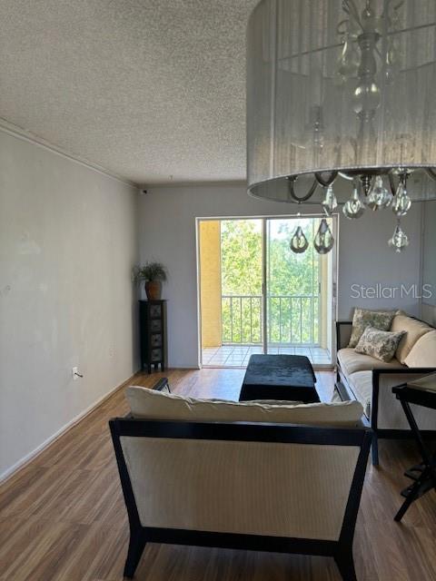 3780 Lake Bayshore Dr Unit K-521, Bradenton, FL 34205 - living room featuring a textured ceiling and wood finished floors