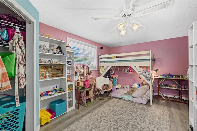 bedroom with a ceiling fan and wood finished floors