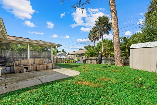 view of yard featuring an outbuilding, fence, and a shed