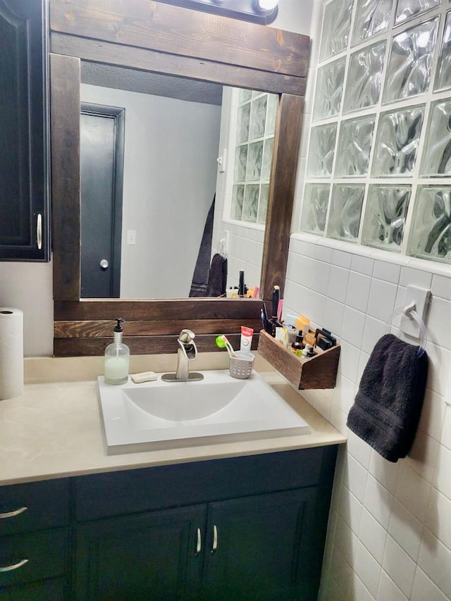 bathroom with tile walls and vanity