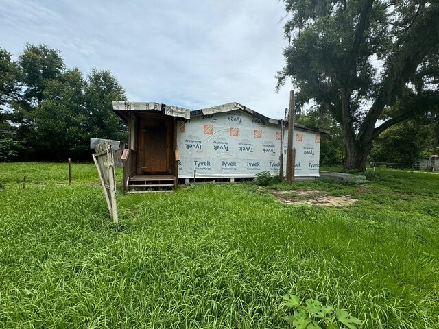 view of outdoor structure featuring a lawn