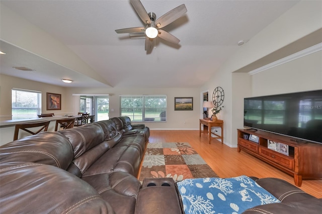 living room featuring lofted ceiling, light hardwood / wood-style flooring, and ceiling fan