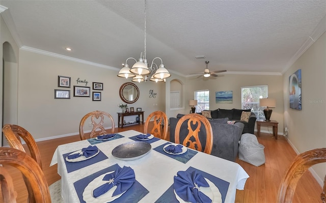 11622 Summit Rock Ct, Parrish, FL 34219 - dining area featuring light wood finished floors, arched walkways, baseboards, ornamental molding, and a ceiling fan