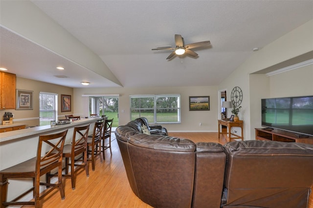11622 Summit Rock Ct, Parrish, FL 34219 - living area featuring lofted ceiling, light wood finished floors, a ceiling fan, and recessed lighting