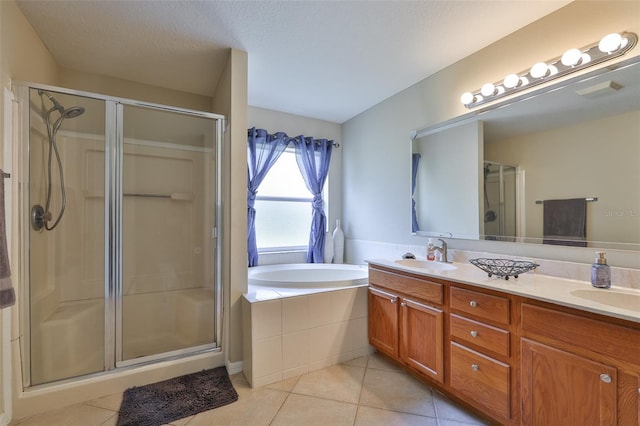 11622 Summit Rock Ct, Parrish, FL 34219 - full bath with tile patterned floors, a shower stall, double vanity, and a bath