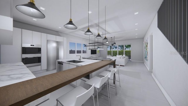 kitchen featuring white cabinets, sink, hanging light fixtures, light tile patterned floors, and oven