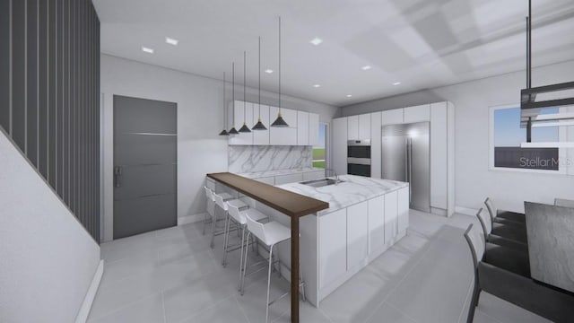 kitchen featuring stainless steel built in fridge, sink, decorative light fixtures, light tile patterned flooring, and white cabinetry