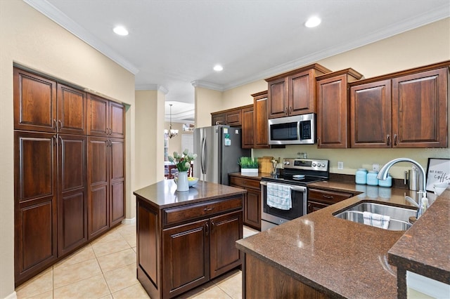 kitchen featuring light tile patterned flooring, an inviting chandelier, a kitchen island, appliances with stainless steel finishes, and sink