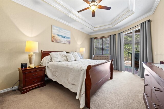 bedroom featuring access to exterior, ceiling fan, a tray ceiling, light colored carpet, and ornamental molding