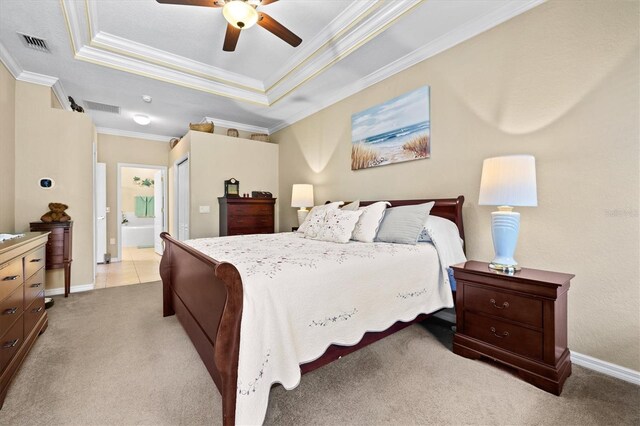 bedroom with ornamental molding, ensuite bathroom, ceiling fan, and a raised ceiling