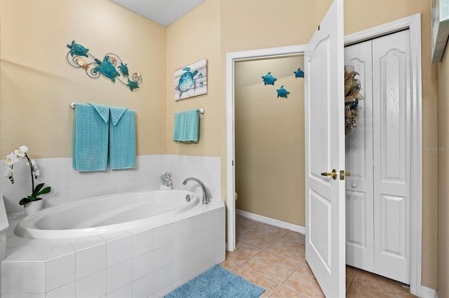 bathroom featuring a relaxing tiled tub and tile patterned floors