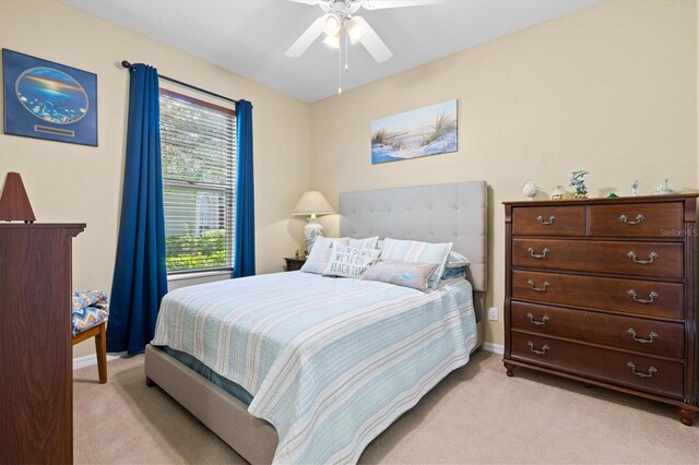 bedroom with light carpet and ceiling fan