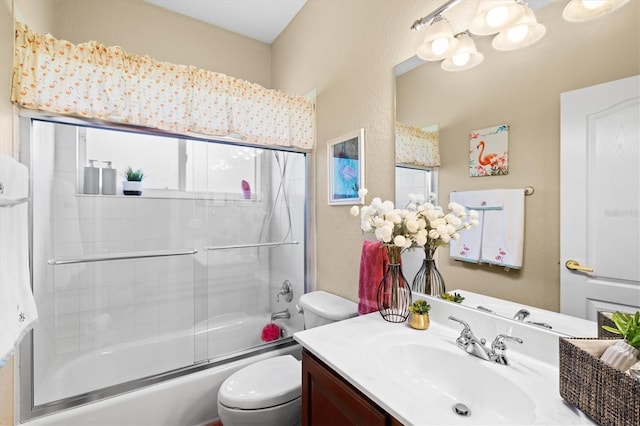 full bathroom featuring toilet, vanity, and enclosed tub / shower combo