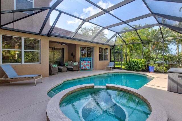 view of swimming pool with a patio area, ceiling fan, an in ground hot tub, glass enclosure, and an outdoor living space