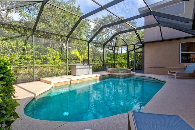 view of swimming pool featuring an in ground hot tub, a lanai, and a patio