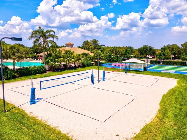 view of home's community with a yard and volleyball court