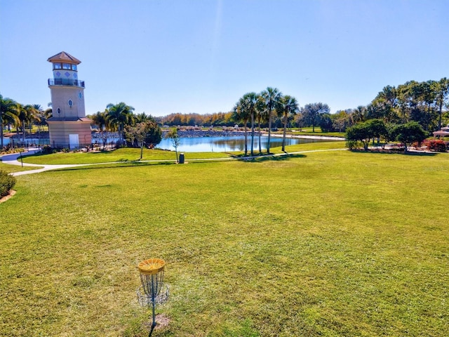 view of home's community featuring a water view and a yard