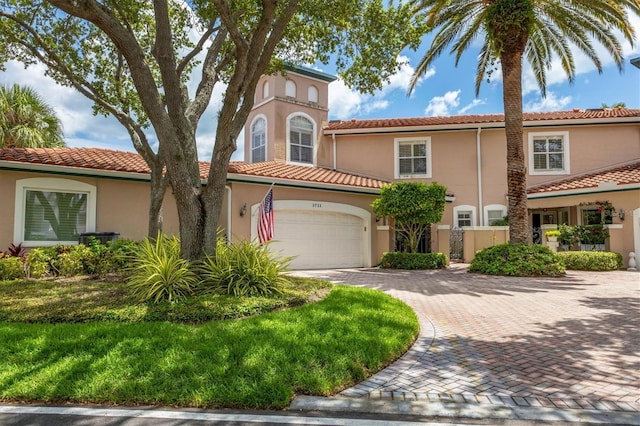 mediterranean / spanish-style home with a garage