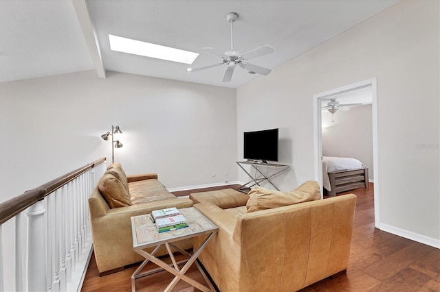 living room with lofted ceiling with skylight, ceiling fan, and dark hardwood / wood-style flooring